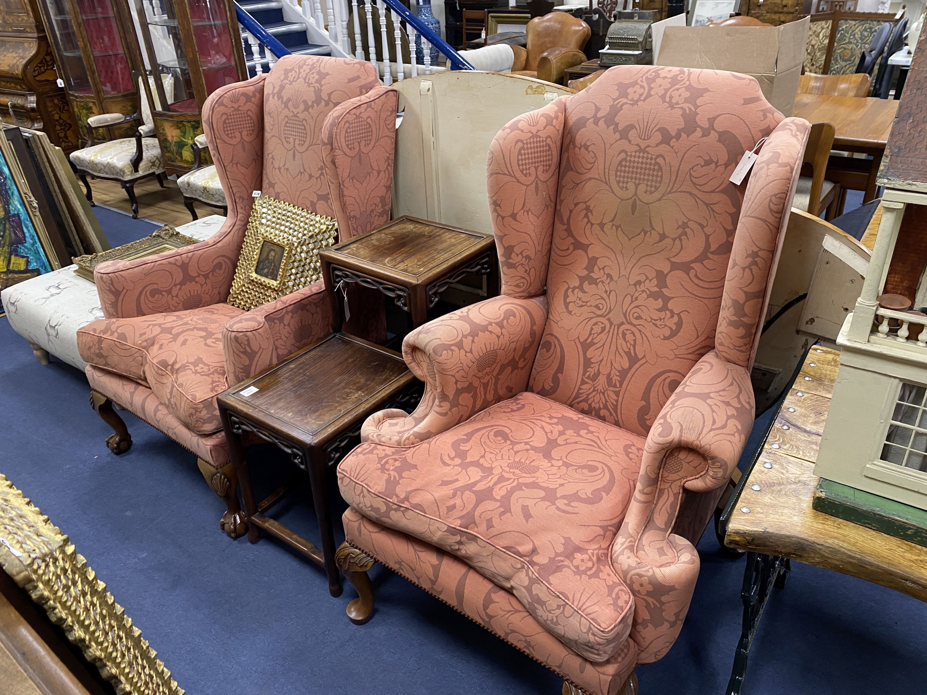 A pair of George I style upholstered wing armchairs on acanthus carved oak feet, width 82cm, depth 86cm, height 124cm